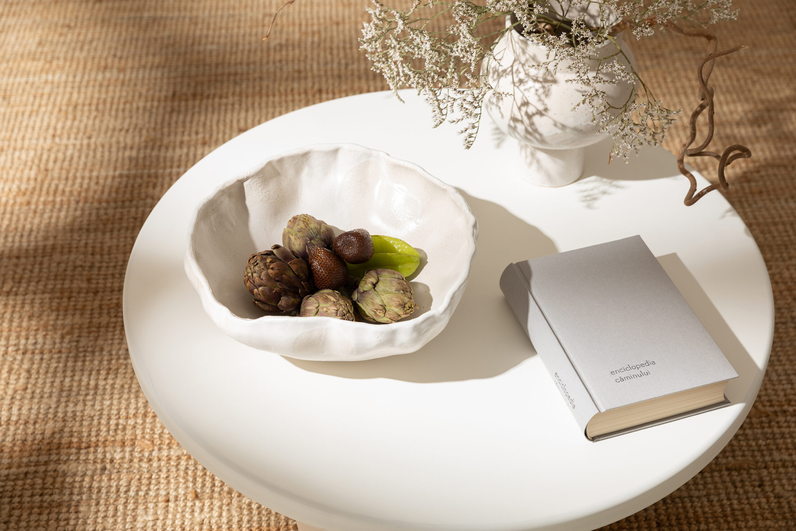 White wooden coffee table with three sphere-shaped legs, inspired by the elegance of solid geometry, designed by 1988 Cultivating Spaces